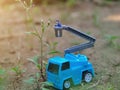Miniature People and toys: Worker at the construction with chery picker truck background Royalty Free Stock Photo