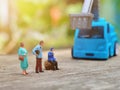 Miniature People and toys: Worker at the construction with chery picker truck background Royalty Free Stock Photo