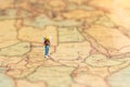 Miniature people : traveler walking on the map. Used to travel to destinations on travel business background concept Royalty Free Stock Photo