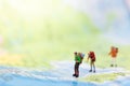 Miniature people : traveler walking on the map. Used to travel to destinations on travel business background concept Royalty Free Stock Photo