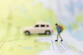 Miniature people : traveler walking on the map. Used to travel to destinations on travel business background concept Royalty Free Stock Photo