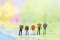 Miniature people : traveler walking on the map. Used to travel to destinations on travel business background concept Royalty Free Stock Photo