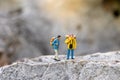 Miniature people : traveler walking on the road. Used to travel to destinations on travel business background concept Royalty Free Stock Photo