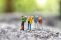 Miniature people : traveler walking on the road. Used to travel to destinations on travel business background concept Royalty Free Stock Photo