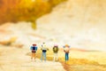 Miniature people: travelers with backpack standing on world map, walking to destination. Image use for travel business concept Royalty Free Stock Photo