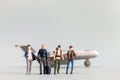 Miniature people, travelers embarks on a delightful vacation, gleefully boarding a tiny airplane