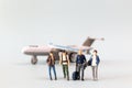 Miniature people, travelers embarks on a delightful vacation, gleefully boarding a tiny airplane