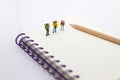 Miniature people: travelers standing on the book, traveling to destination. Use image for travel business concept