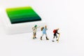 Miniature people: Traveller with backpack walking on the path of tourism. Travel, explore and adventure concept Royalty Free Stock Photo