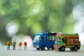 Miniature people : Traveller backpacker standing with Thai farming trucks and Thai style taxi
