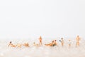 Miniature people wearing swimsuit relaxing on bubble