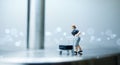 Miniature people - A woman pushes a cart with luggage