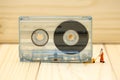 Miniature people : worker with Audio cassette with magnetic tape Royalty Free Stock Photo