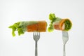 Miniature people worker digging into the salad of fresh vegetablSalad of fresh vegetables rolls on a fork isolated on white backgr Royalty Free Stock Photo