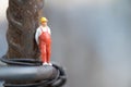 Miniature people worker occupation standing on steel pole Royalty Free Stock Photo