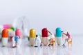 Miniature people: Worker are painting color on medicinal capsules. Image use for Mechanisms of drug production, Healthcare concept