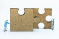 Miniature people : Worker pushing back jigsaw puzzle pieces . Image use for solve, finding solution, business vision concept Royalty Free Stock Photo