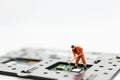 Miniature people: Worker repairing circuit board ,electronics repair. Use image for support and maintenance business