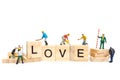 Miniature people : Worker team building word ` Love ` on wooden block