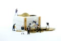 Miniature people : worker team and businessman with treasure coffer of gold.