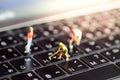 Miniature people : worker team with button on a computer keyboa Royalty Free Stock Photo