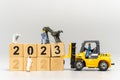 Miniature People Worker Team Create Number 2023 On Wooden Block