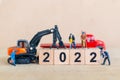 Miniature people : Worker team create wooden block number 2022