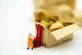 Miniature people: Worker transportation golden coin Royalty Free Stock Photo