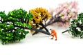 Miniature people : worker using a chainsaw to cut down a large beech tree, Deforestation concept Royalty Free Stock Photo