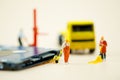 Miniature people: Workers moving circuit board for repair