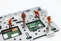 Miniature people: Workers repairing circuit board ,electronics repair. Use image for support and maintenance business
