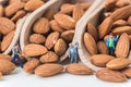 miniature people working on raw natural whole almonds in the scoop