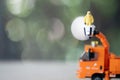 Miniature people in yellow protective suit on bucket truck