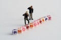 Miniature Photographers taking pictures behind a Group Of Letters forming Word Spelling