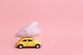 Miniature pink and yellow cars carrying heart cushions. Minimal concept Royalty Free Stock Photo