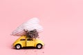 Miniature pink and yellow cars carrying heart cushions. Minimal concept Royalty Free Stock Photo