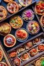 miniature pizzas with different toppings on a large baking tray