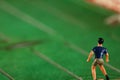 Miniature plastic figure model of soccer player. Royalty Free Stock Photo