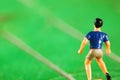 Miniature plastic figure model of soccer player. Royalty Free Stock Photo