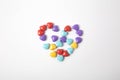 Miniature plastic hearts on white background