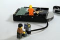 Miniature IT Professional Diagnosing and Fixing Hard Drive Royalty Free Stock Photo