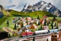 Miniature railway model with model freight train on a mountains ambientation. Toy Train