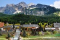 Miniature railway model with model steam locomotive train at station on a mountains ambientation. Toy Train