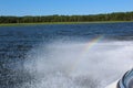 A miniature rainbow shining in the spray from a speedboat near the salt marshes of Wallace Bay, Nova Scotia