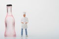 Miniature figurine of a chef with a giant bottle of wine