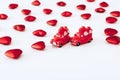 Miniature red cars and red hearts on white background. Valentine Day concept Royalty Free Stock Photo