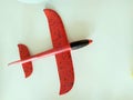 Miniature of a red plane on a white background. Styrofoam plane. Children is toy . Concept - air travel, booking tickets