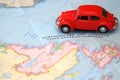 Miniature car driving on a map of Newfoundland Canada