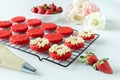 Miniature Red Velvet Cakes with cream cheese frosting and fresh strawberry topping Royalty Free Stock Photo