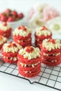 Miniature Red Velvet Cakes with cream cheese frosting and fresh strawberry topping Royalty Free Stock Photo